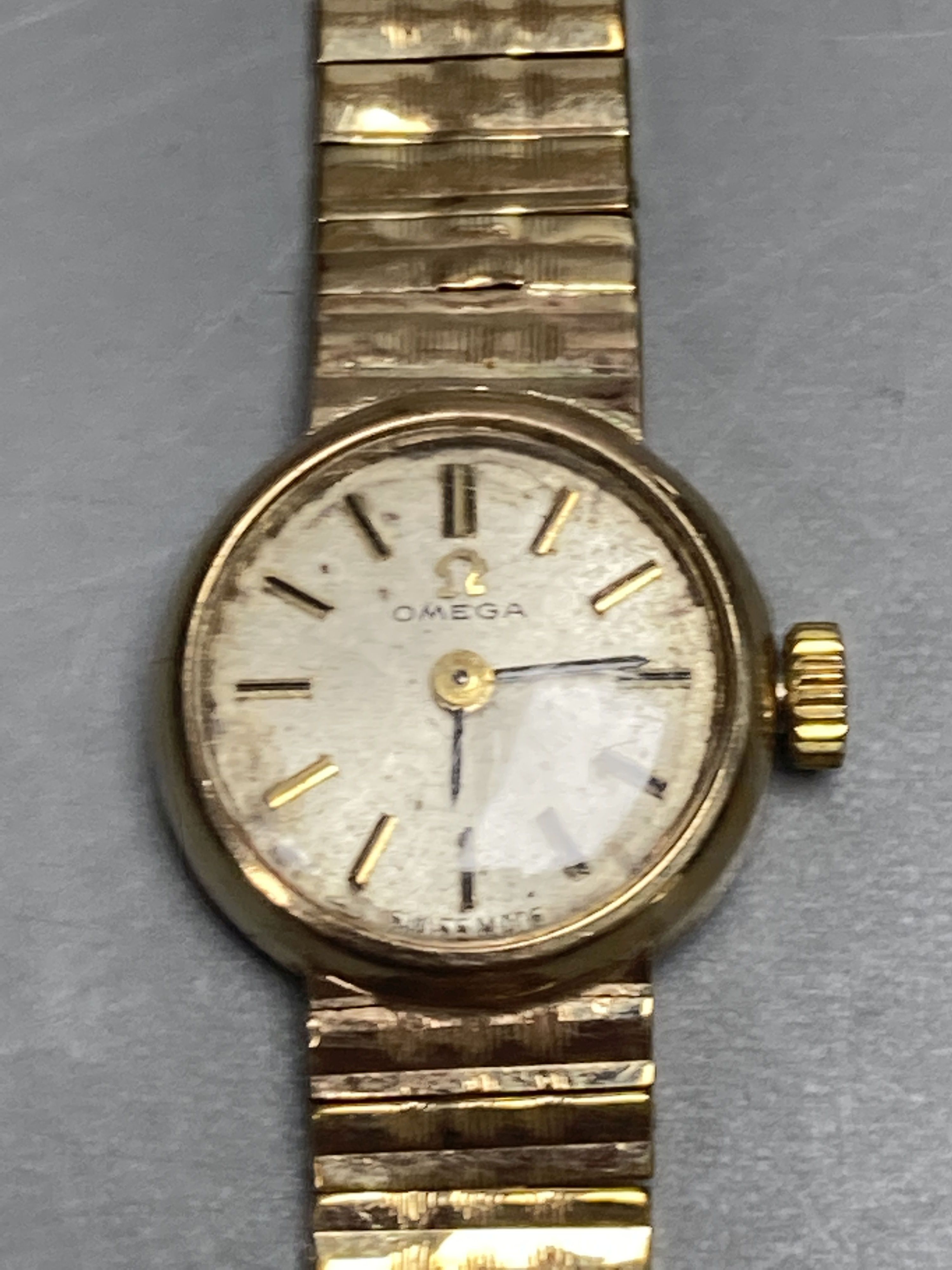 A ladys 1960s 9ct gold Omega manual wind wrist watch, on a 9ct gold Omega bracelet, overall length 18.5mm gross 21.3 grams,